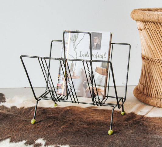 vintage retro metal wire magazine rack or record holder with green wooden ball feet