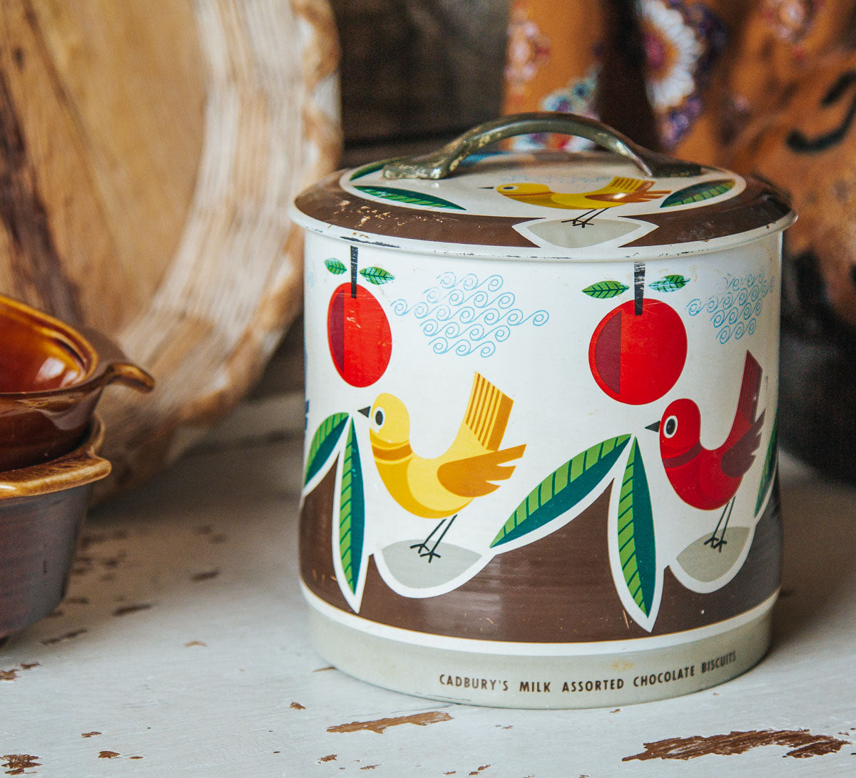 vintage retro cadbury biscuit tin in bright colours with birds on it