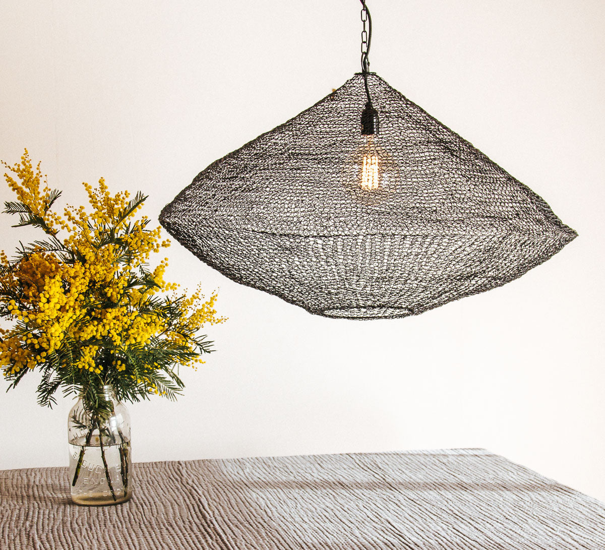 black wire mesh pendant light made from metal links in boho scandi style