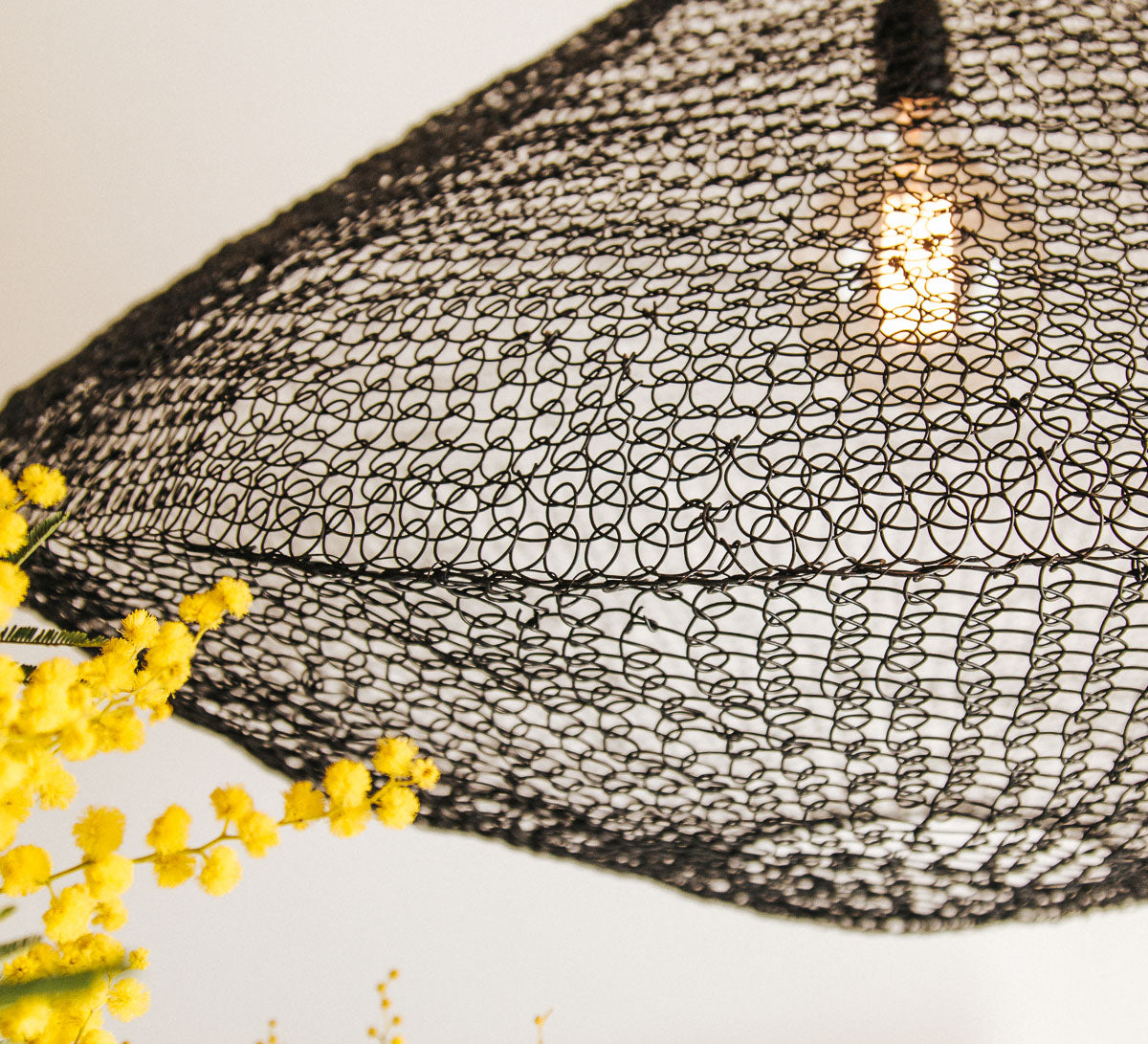 black wire mesh pendant light made from metal links in boho scandi style