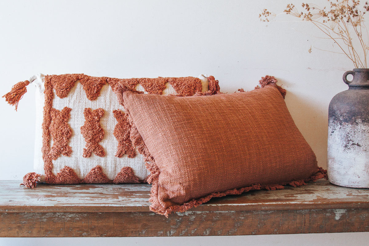 boho woven cotton rust coloured cushion with tufted embroidery and tassles