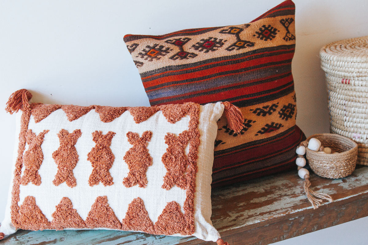 boho woven cotton rust coloured cushion with tufted embroidery and tassles
