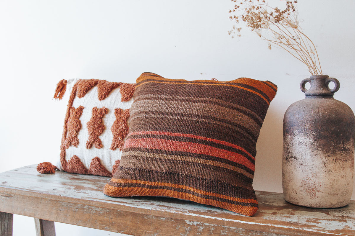 boho woven cotton rust coloured cushion with tufted embroidery and tassles