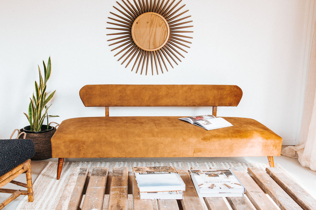 vintage boho mid century modern sofa with oak back and wooden legs.  upholstered in suede-like buttery soft mustard gold velvet couch