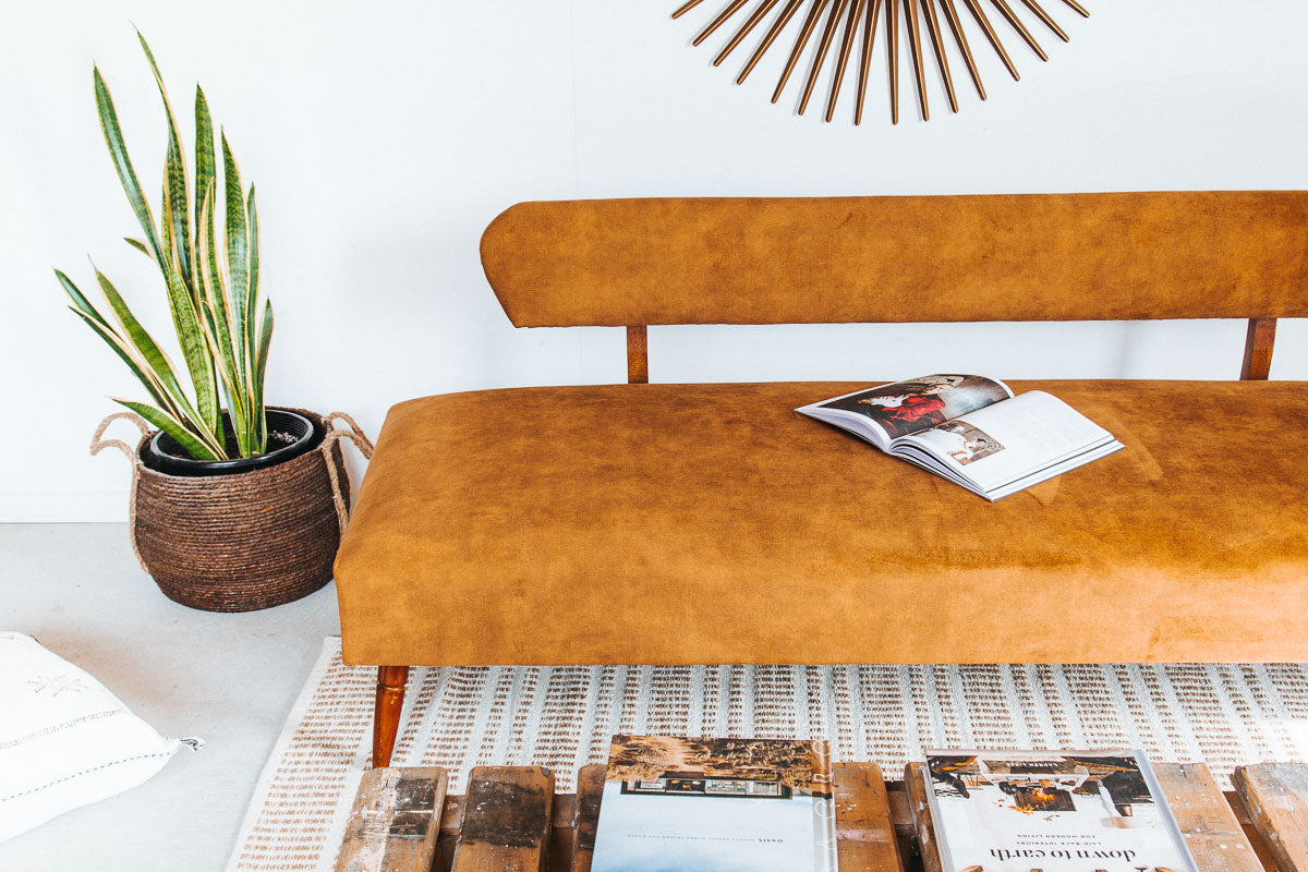 vintage boho mid century modern sofa with oak back and wooden legs.  upholstered in suede-like buttery soft mustard gold velvet couch