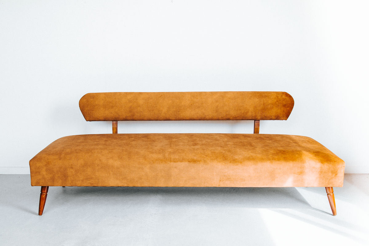 vintage boho mid century modern sofa with oak back and wooden legs.  upholstered in suede-like buttery soft mustard gold velvet couch
