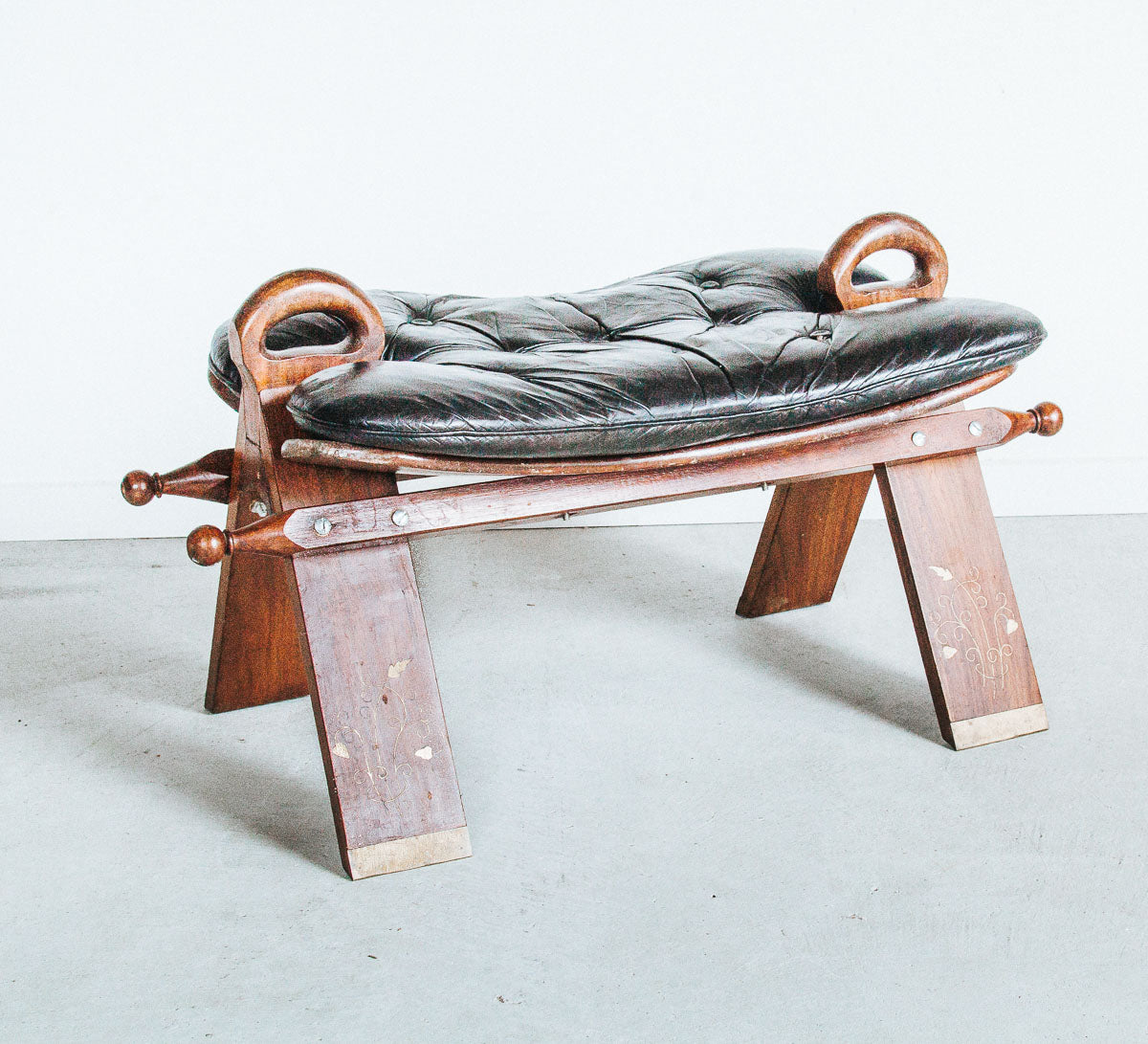 vintage boho camel saddle stool with black leather seat, brass inlaid wooden legs