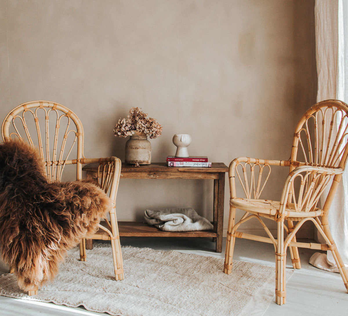 vintage retro boho bohemian designer cane rattan chairs with rustic sheepskin