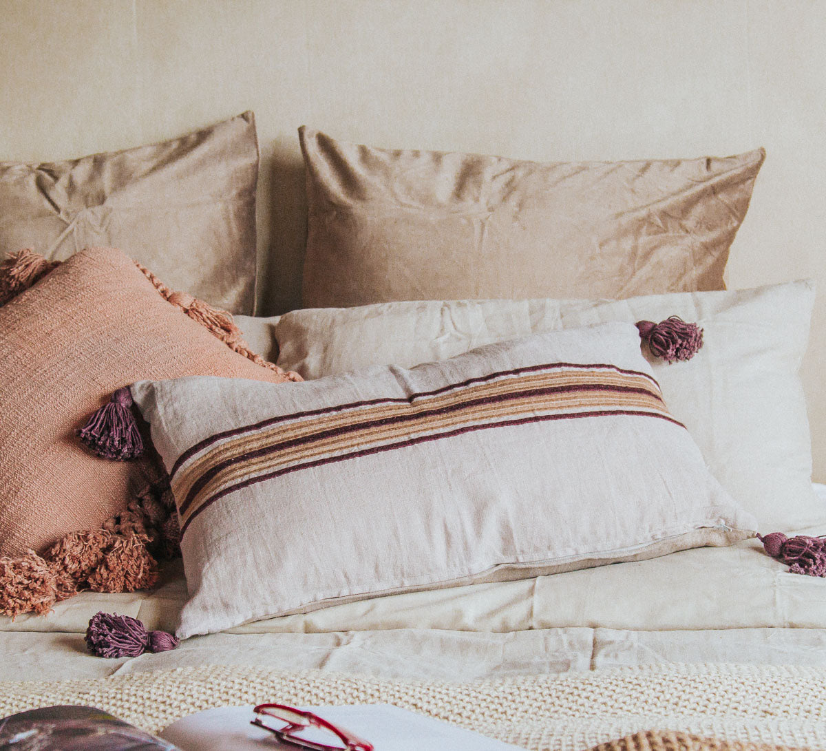 madam stoltz linen throw pillow cushion boho style with tassles and embroidered stripe in aubergine and gold