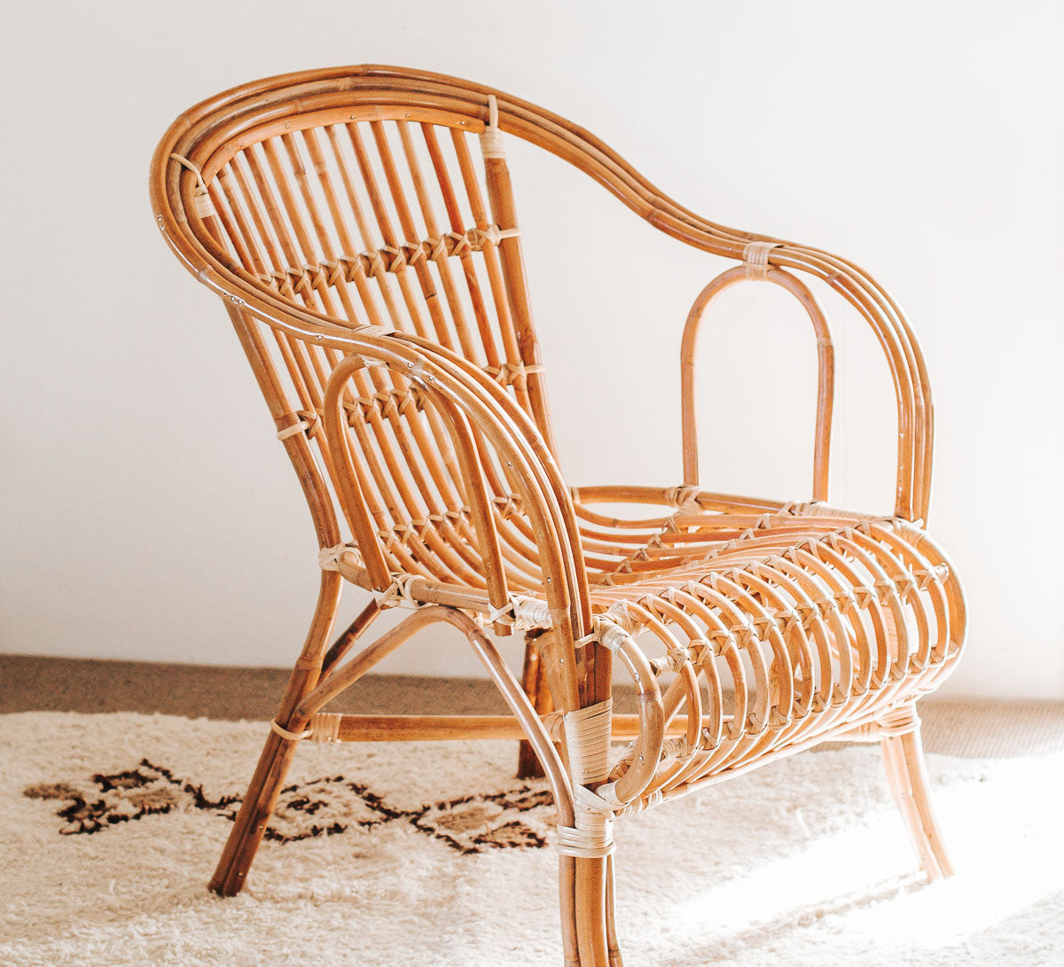 Wicker chair on a light-colored floor with a neutral background