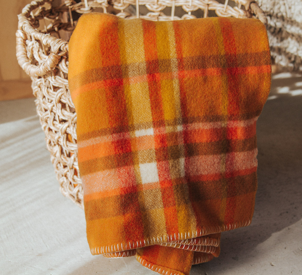 vintage retro boho nz made wool plaid check blanket in bright orange tones