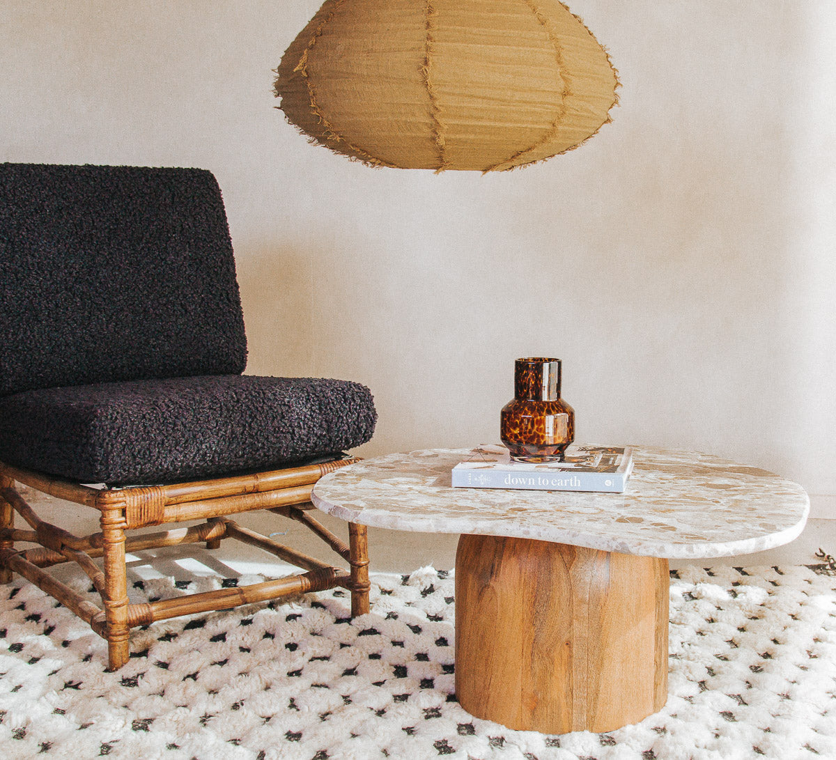 boho designer avi marble coffee table in an organic shape with a round curved solid wood base