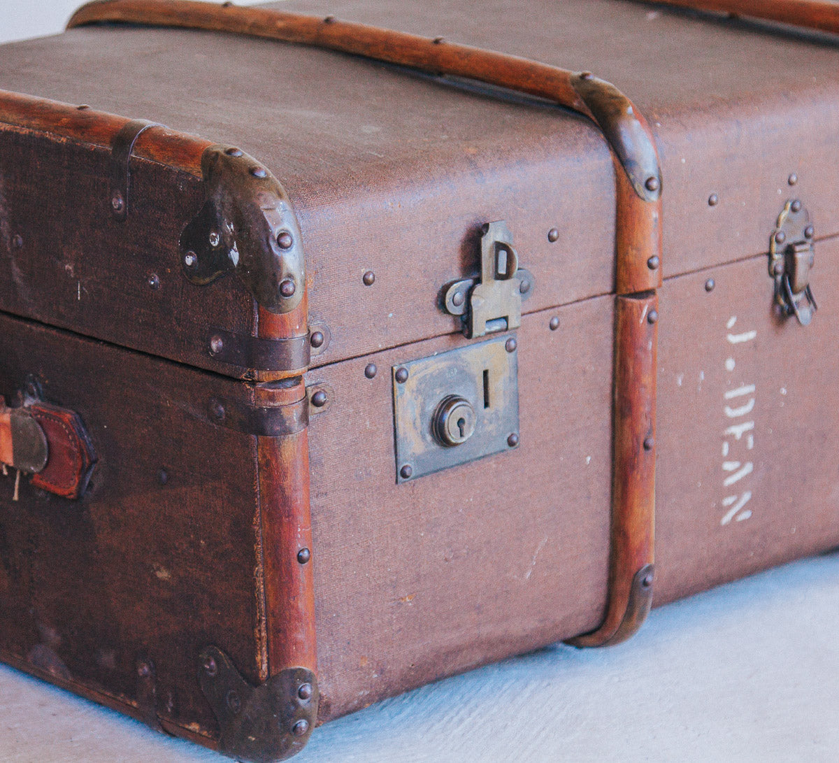 vintage boho antique canvas travel trunk with wooden runners and brass metal corners