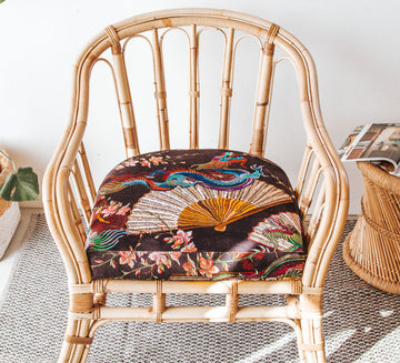 vintage boho cane armchair with black velvet dragon cushion