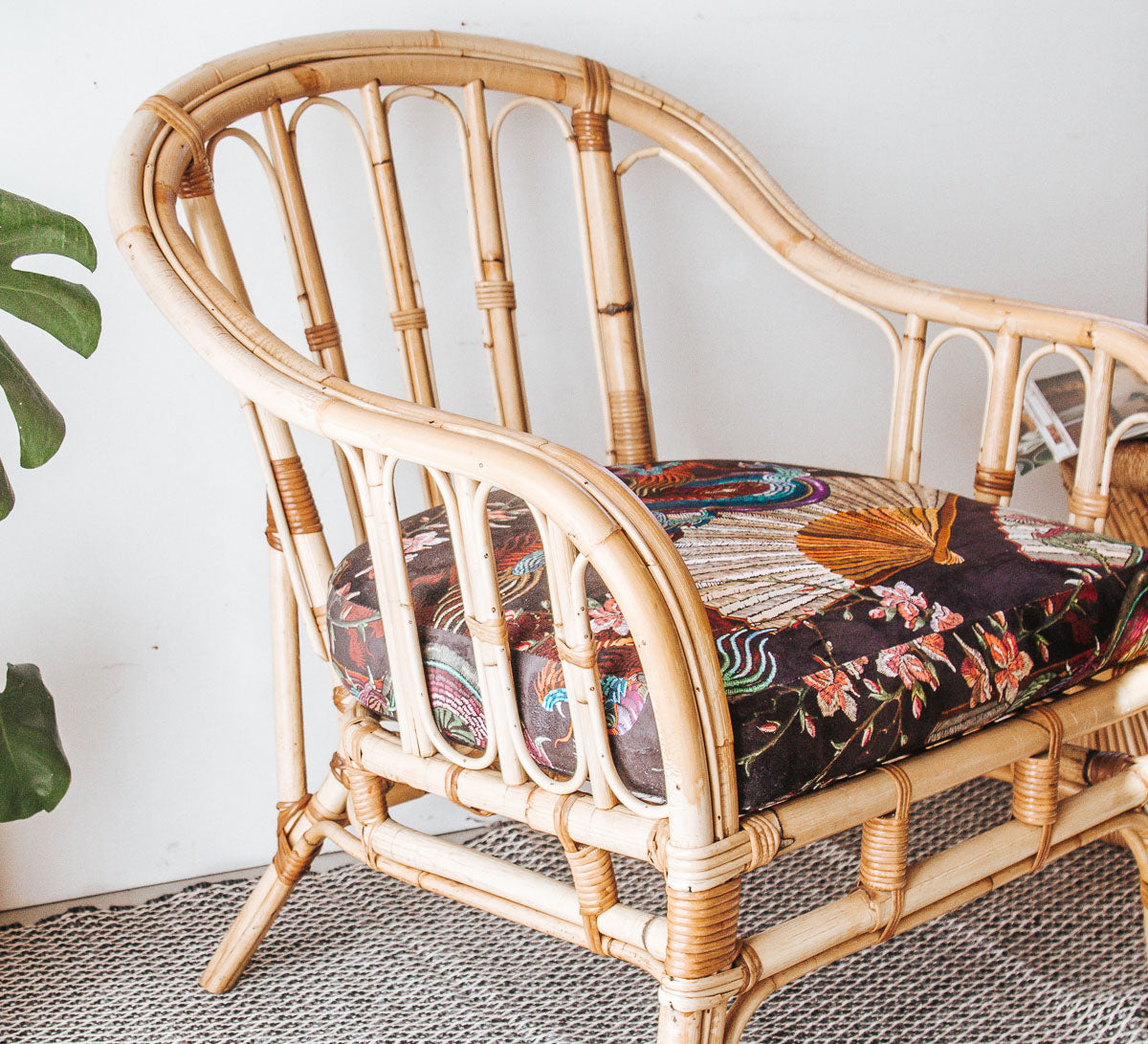 vintage boho cane armchair with black velvet dragon cushion