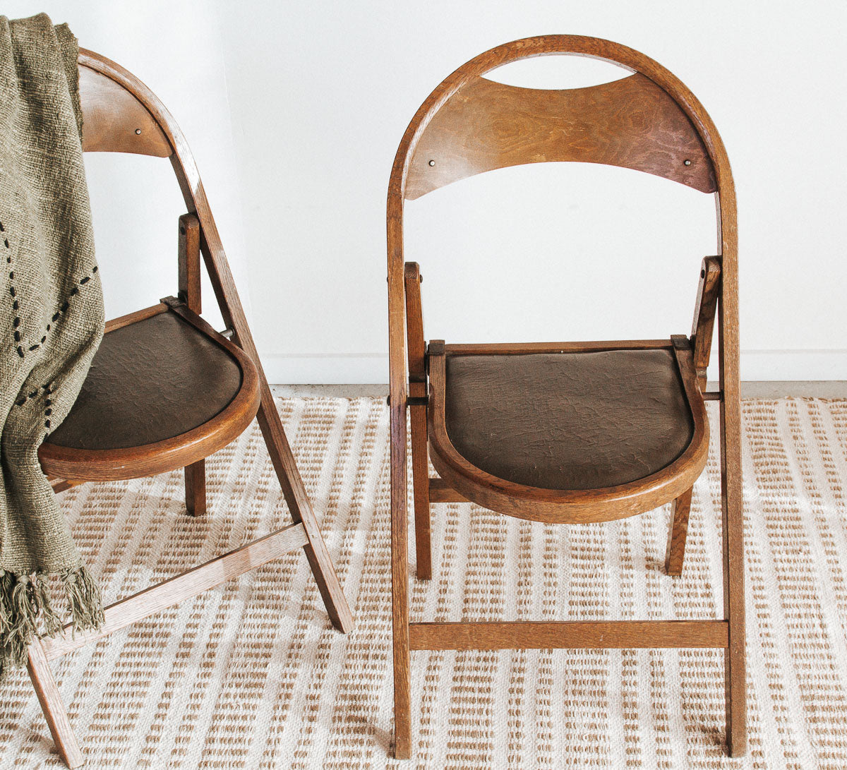 Close-up of vintage wooden folding chair with warm timber tones and detailed seat.