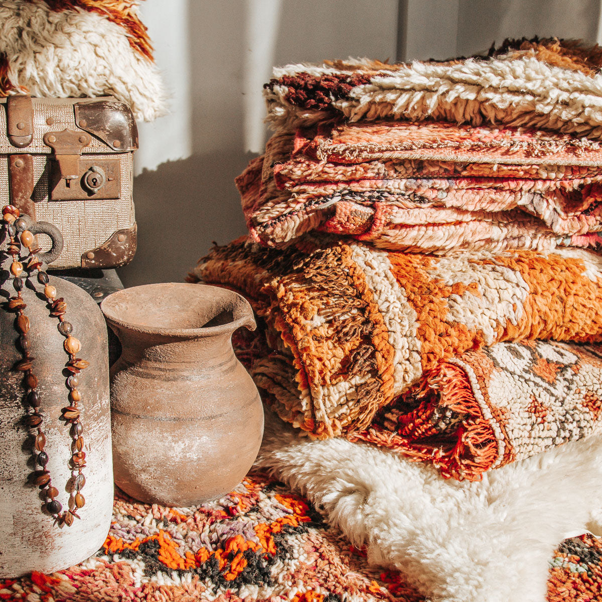 Eclectic mix of vintage homewares, moroccan rugs, clay jars and beads 
